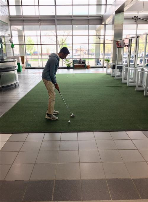 Student golfing  